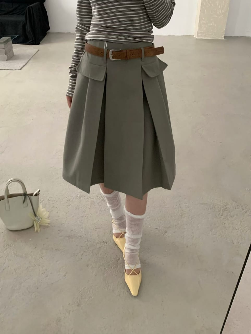 Olive belted pleated mini skirt worn front view