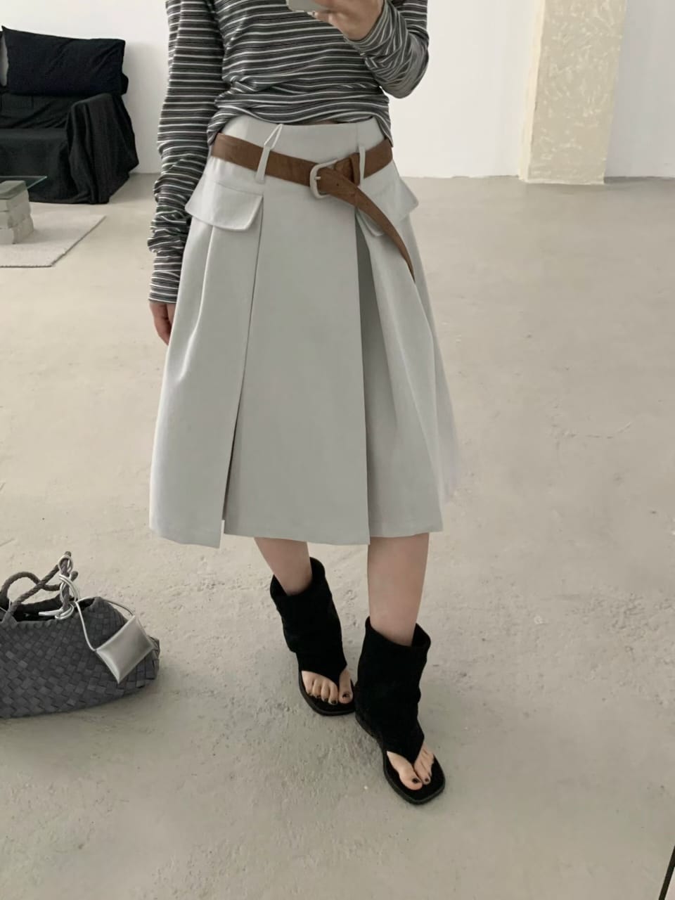 Light grey blue belted pleated mini skirt worn front view