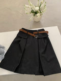 Black belted pleated mini skirt flat lay