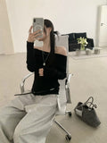 Black off-shoulder ribbed knit top - mirror selfie with grey wide-leg trousers