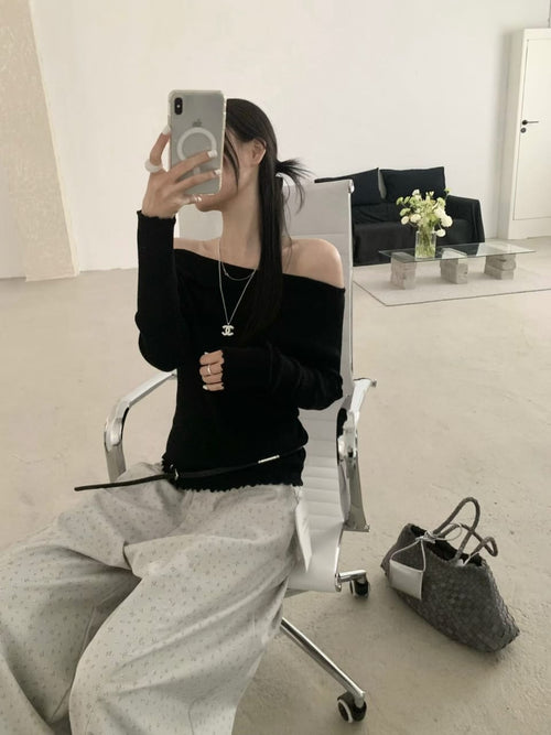 Black off-shoulder ribbed knit top - mirror selfie with grey wide-leg trousers