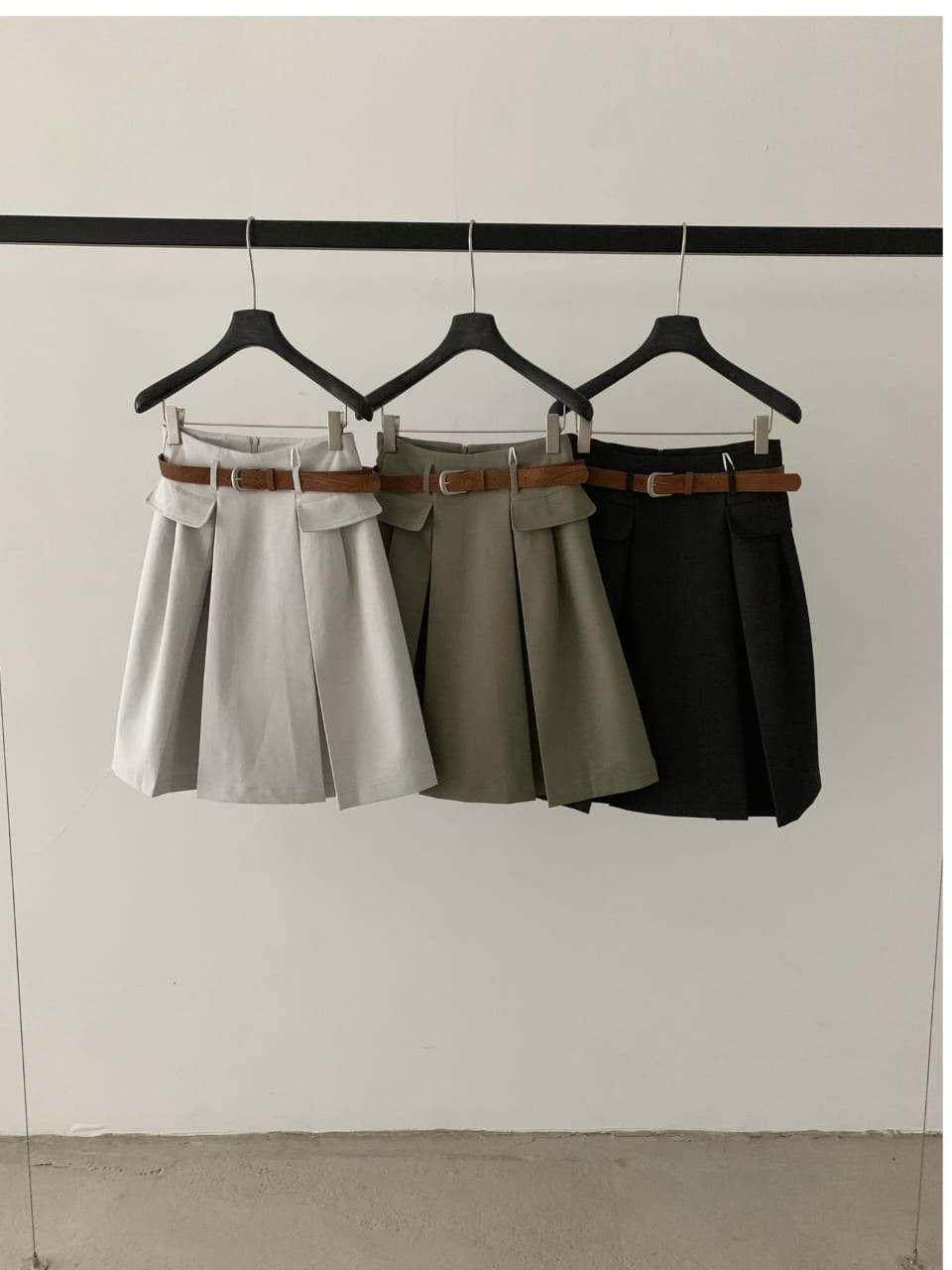 Belted pleated mini skirt in light grey, khaki and black - hanger shot